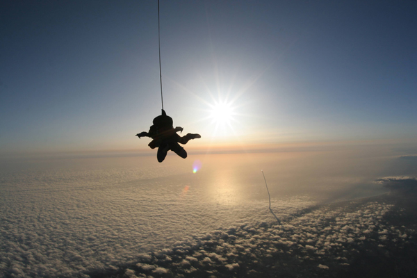 Photo of the day: Sky divers watch shuttle launch
