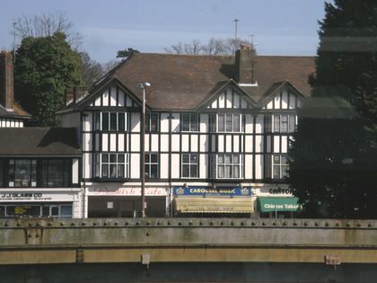 View of a mock-Tudor building seen through a train window. View of a mock-Tudor building seen through a train window.