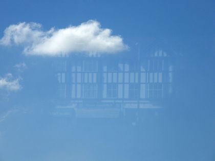 View of a blue sky - but a clear reflection of the mock-Tudor building opposite is also visible. View of a blue sky - but a clear reflection of the mock-Tudor building opposite is also visible.