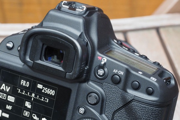Canon's standard live view / video control sits beside the eyepiece, and the AF selector joystick is larger